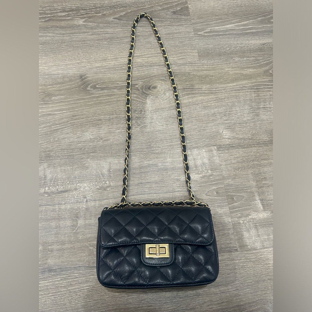Very dark navy cross body or shoulder purse.